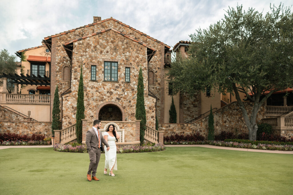 Couple on front lawn at Bella Collina