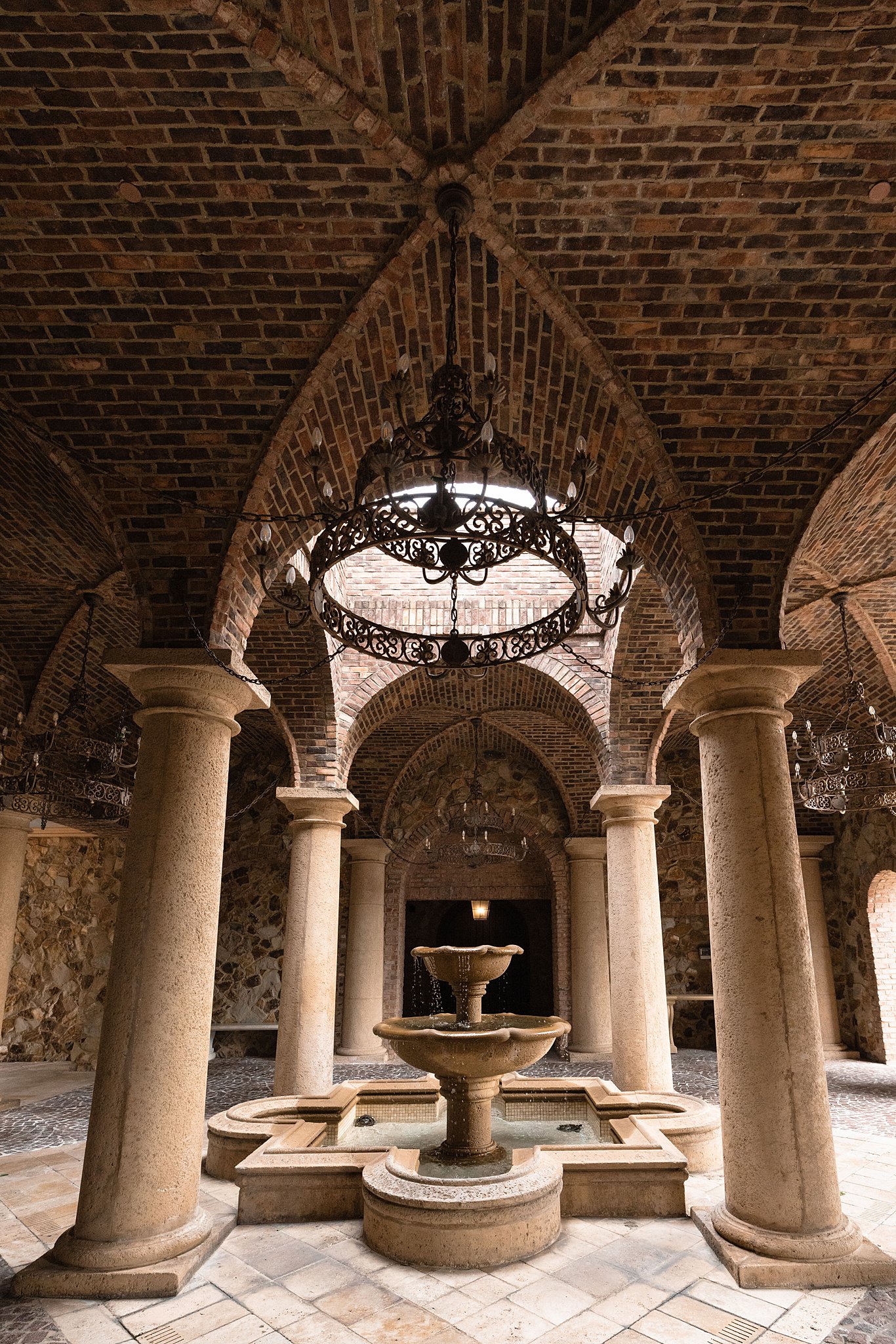 Details of an ornate fountain and open roof structure at the club at bella collina wedding venue