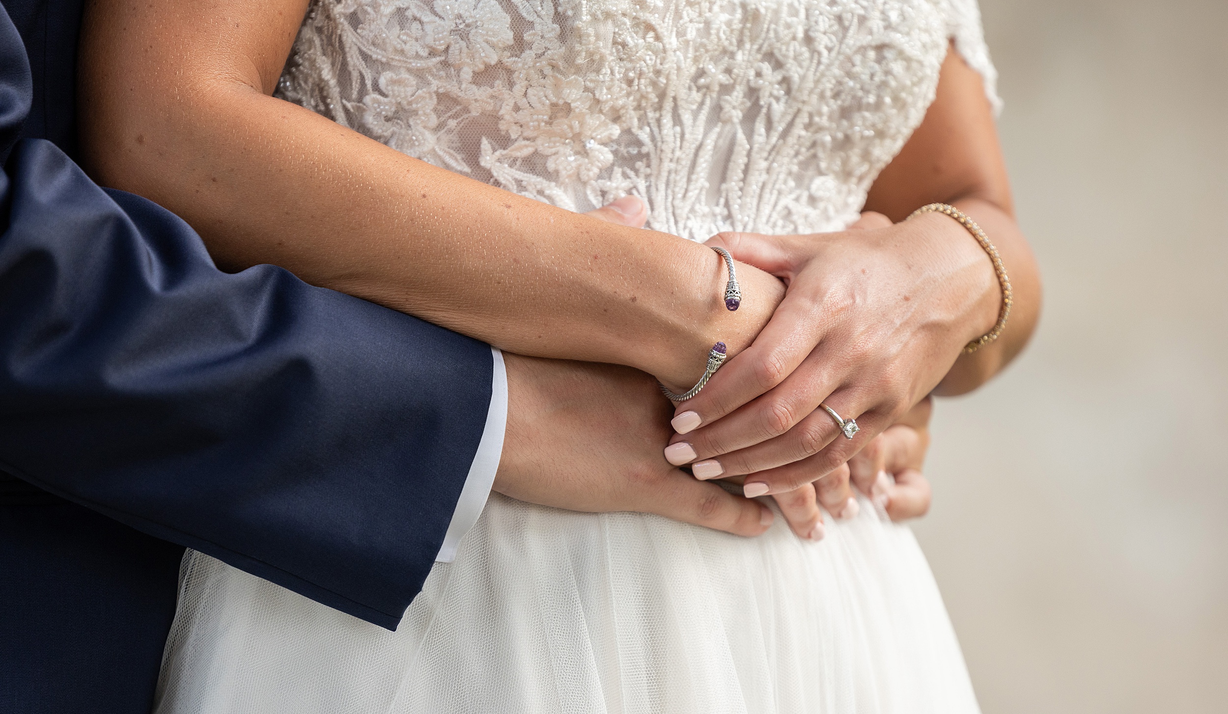 Details of newlyweds standing and hugging at their 9 aviles wedding