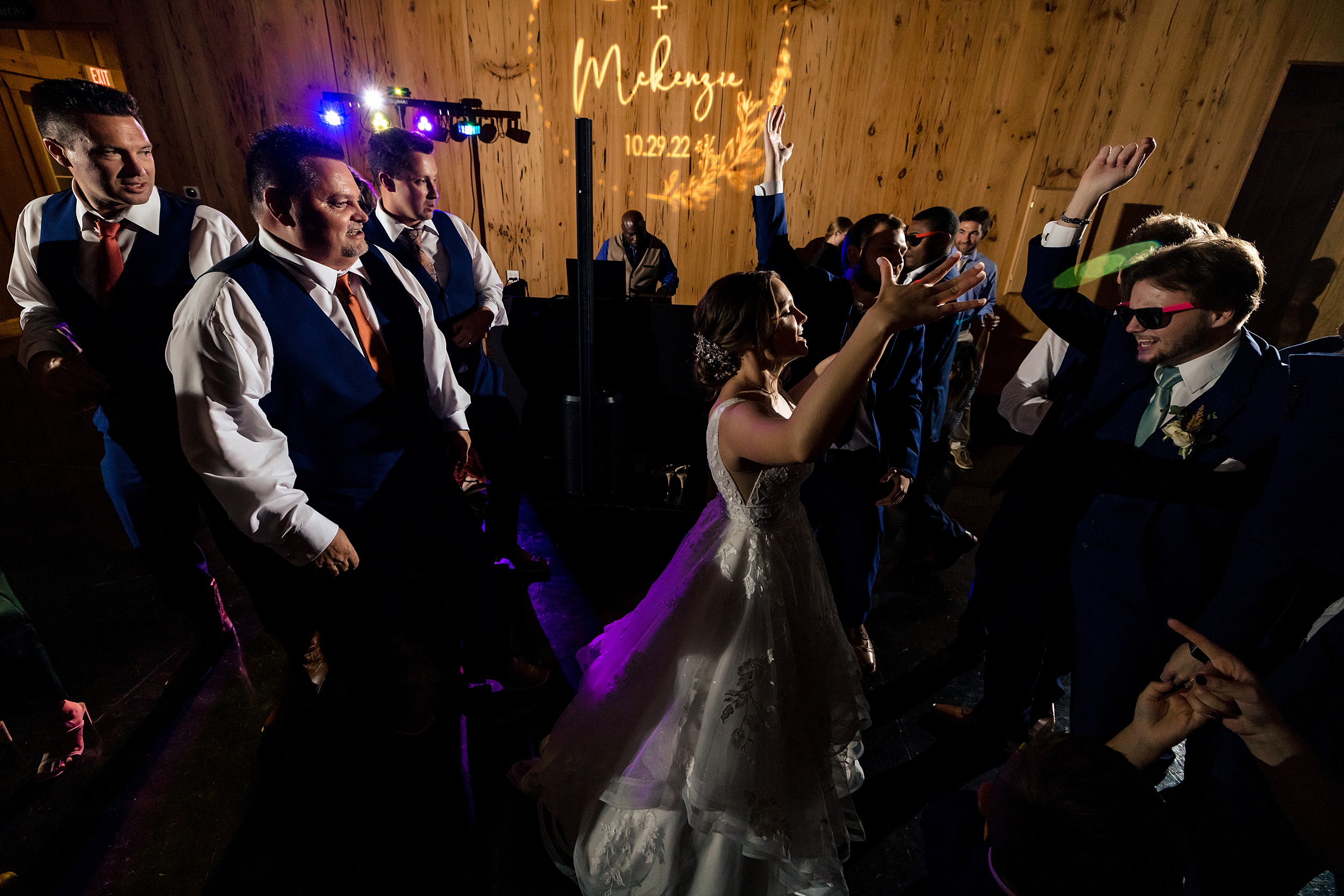 A bride dances in the center of her dance floor with her family at her bowing oaks wedding