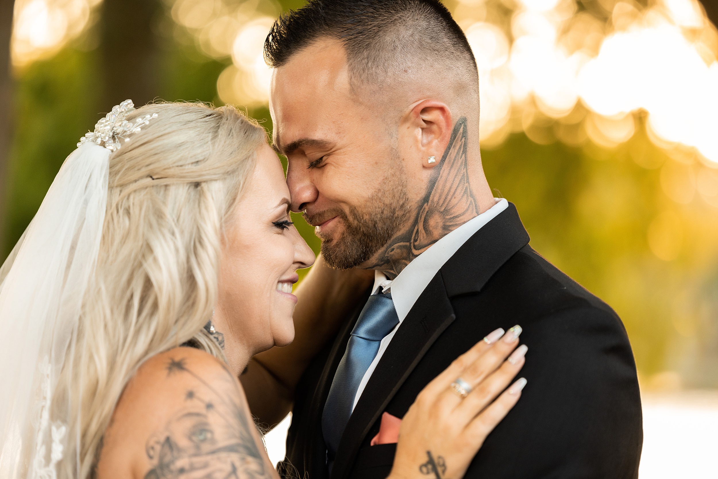 Newlyweds laugh while standing outside at sunset during their chandler oaks barn wedding