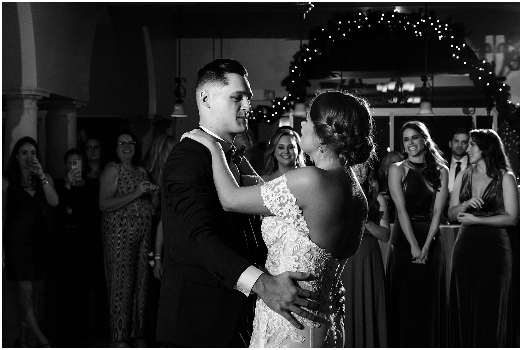Newlyweds dance for the first time surrounded by guests at their club continental wedding