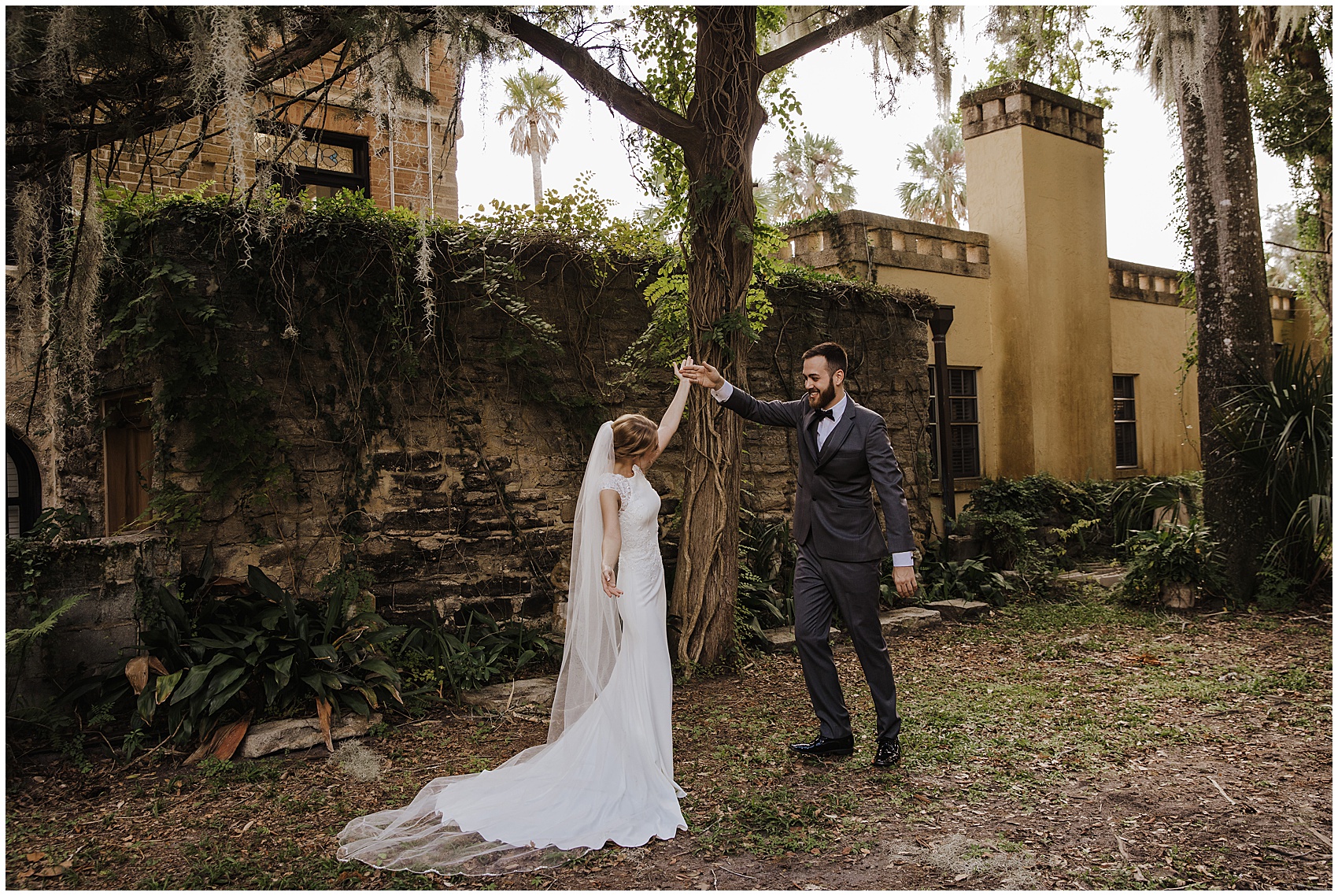 Newlyweds dance in a garden by historical buildings during their flagler college wedding
