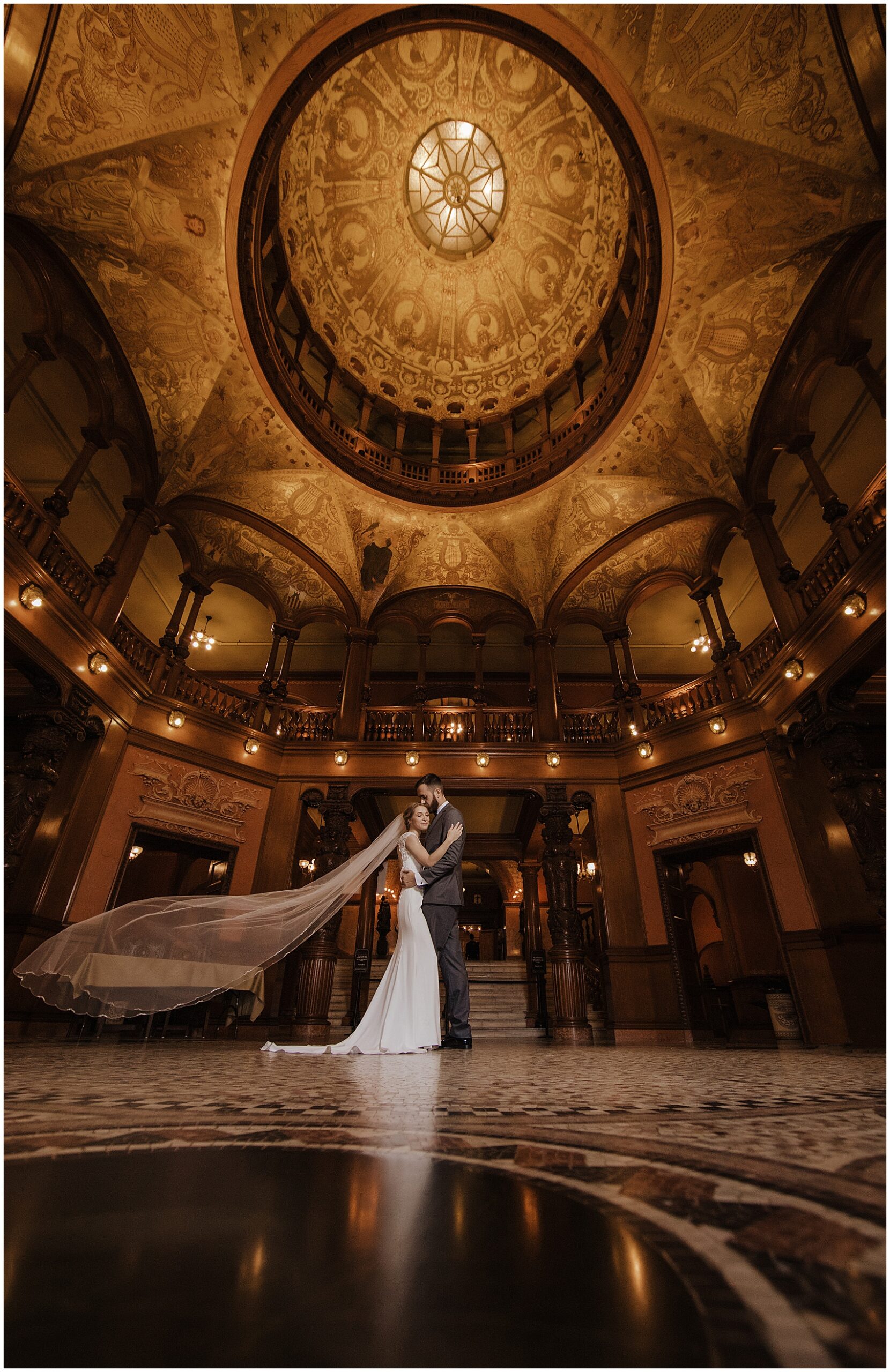 Newlyweds dance close under an ornate ceiling at their flagler college wedding