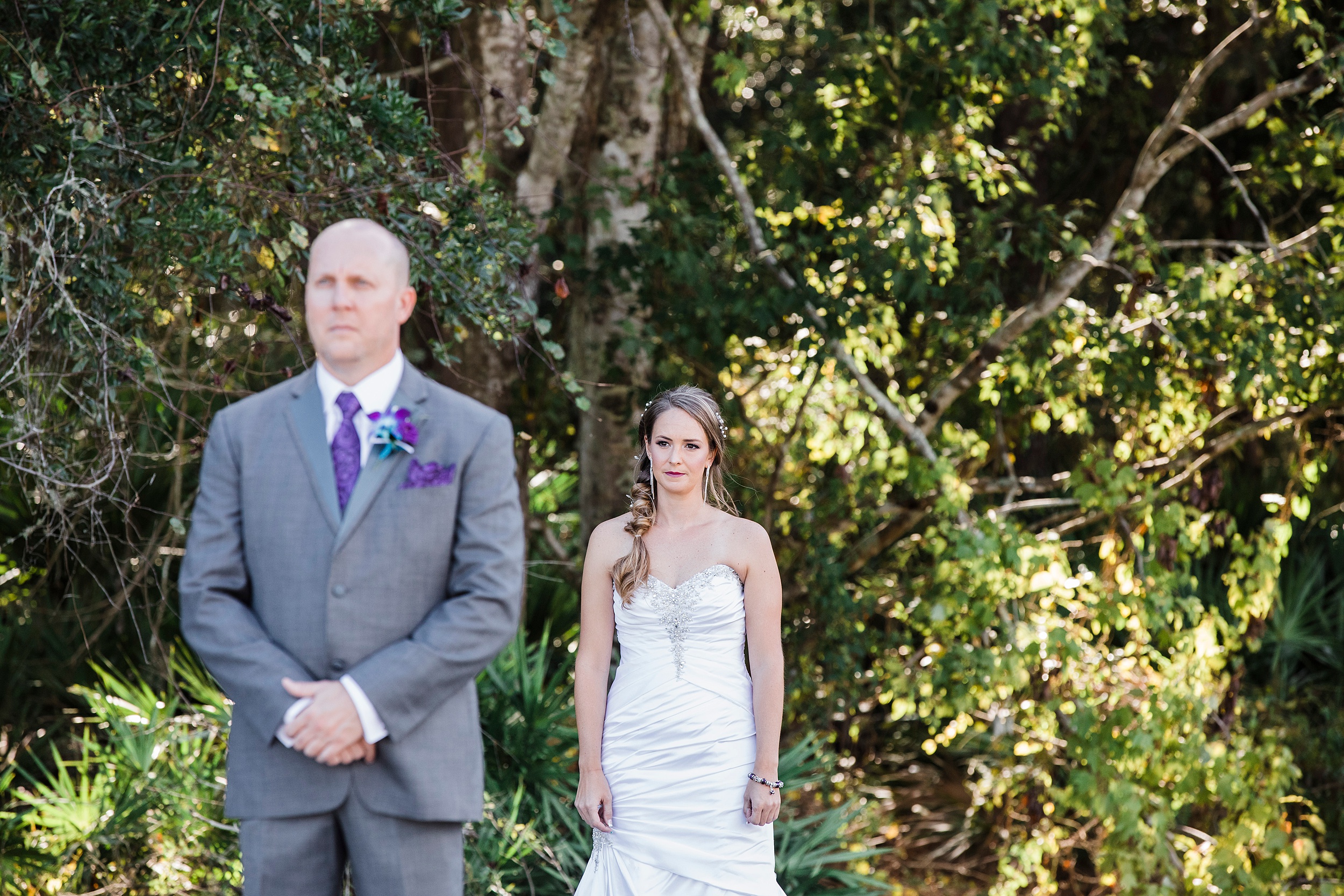 A bride nervously waits to call her husband to turn around for their first look