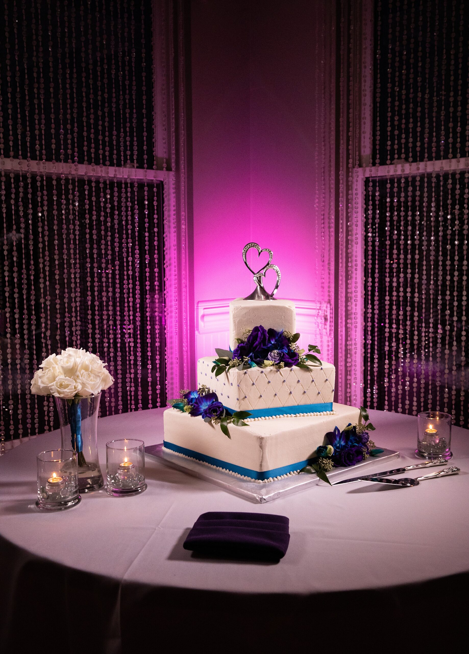 Details of a three tier wedding cake with blue banding