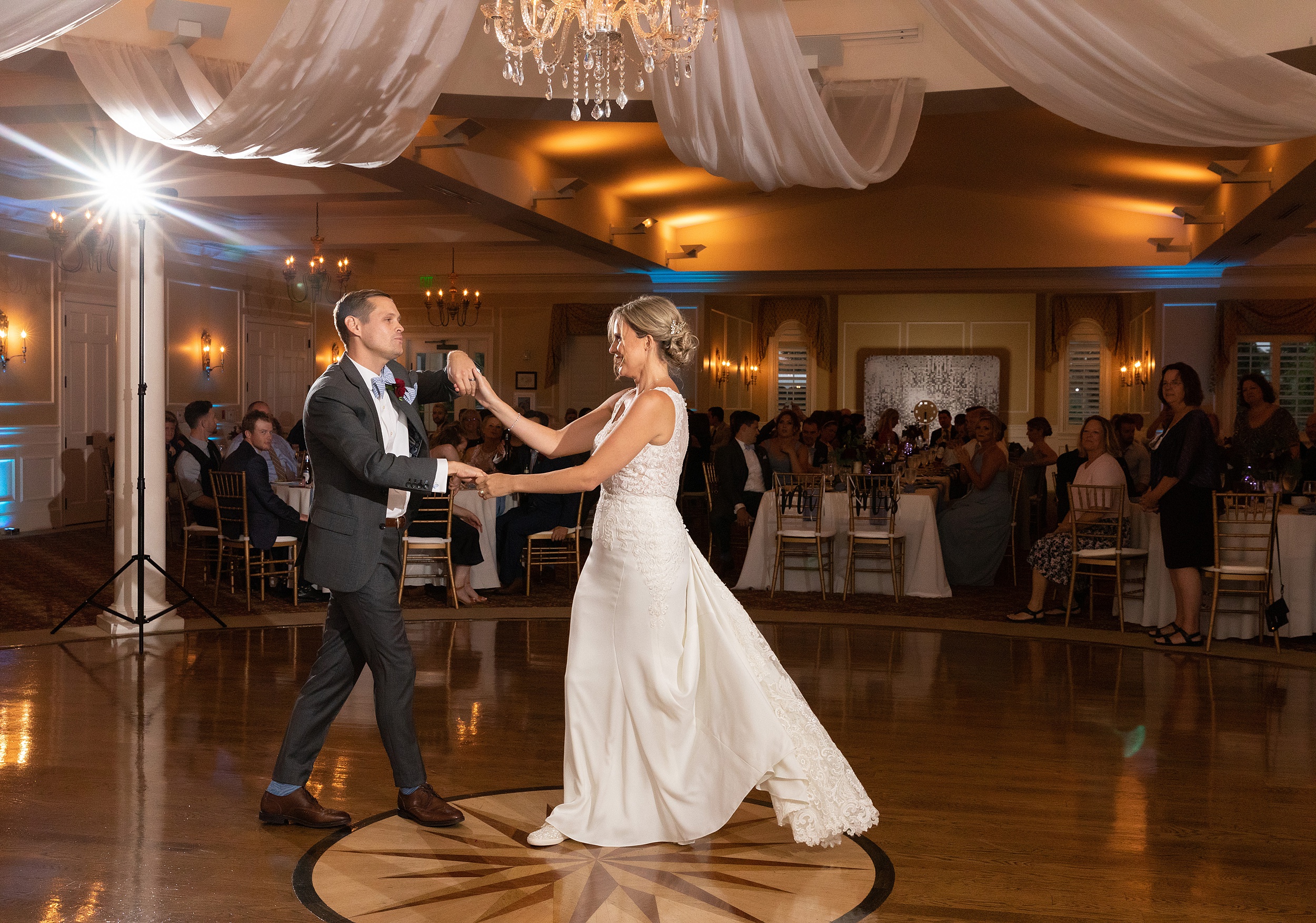 Newlyweds dance in front of their guests at their river house events wedding