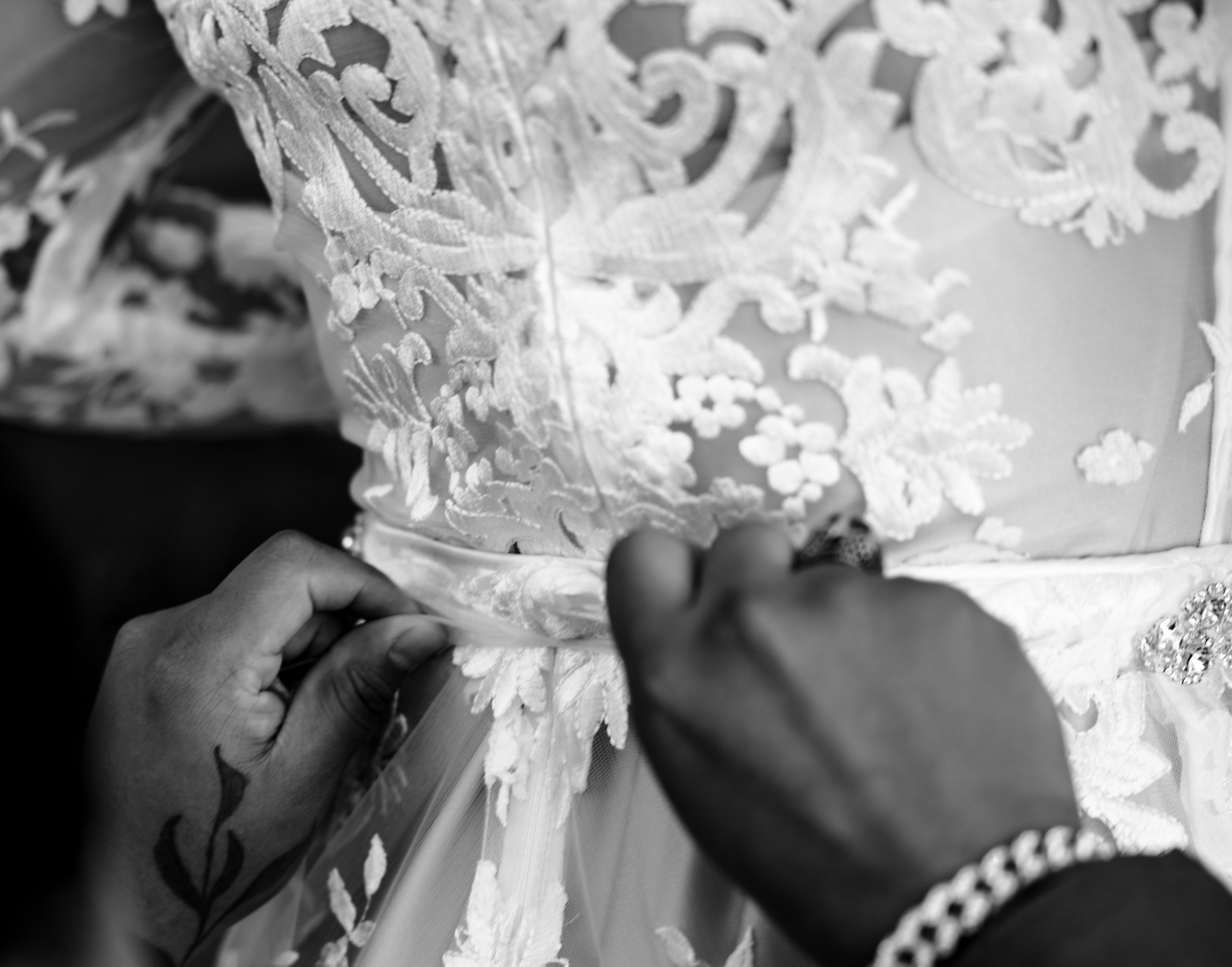 Details of a bride being tied into her lace dress at her a1a ale works wedding