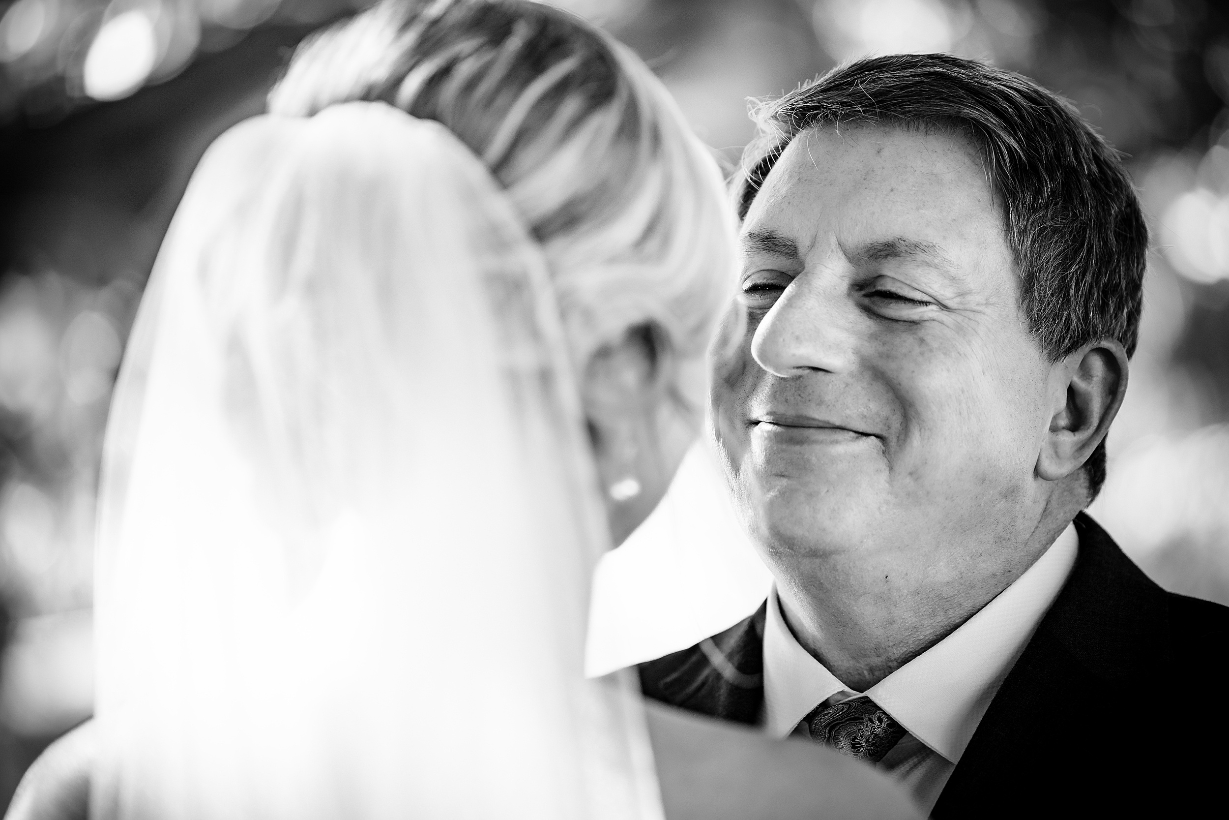 Newlyweds smile while leaning in for a kiss at their alfond inn wedding