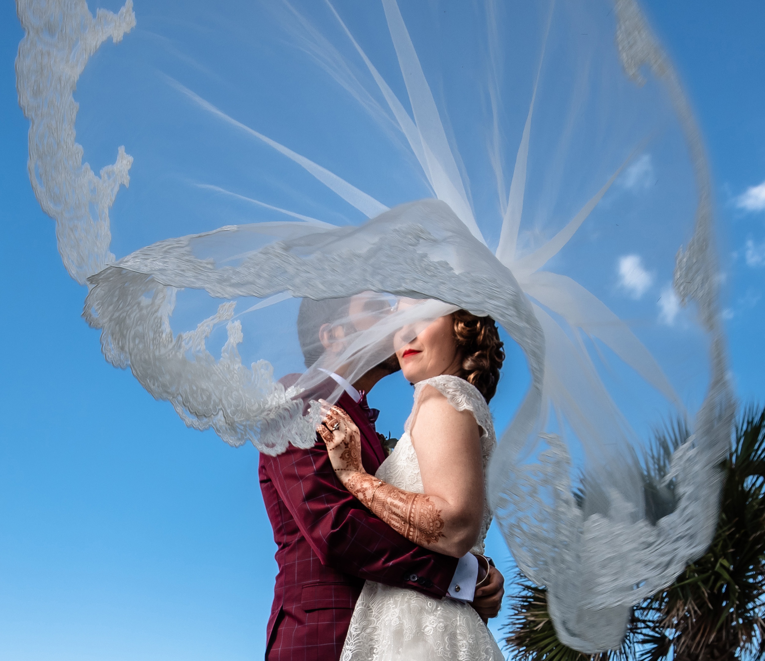 Newlyweds twirl while dancing under blue skies as the veil spins at their historic venue 1902 wedding