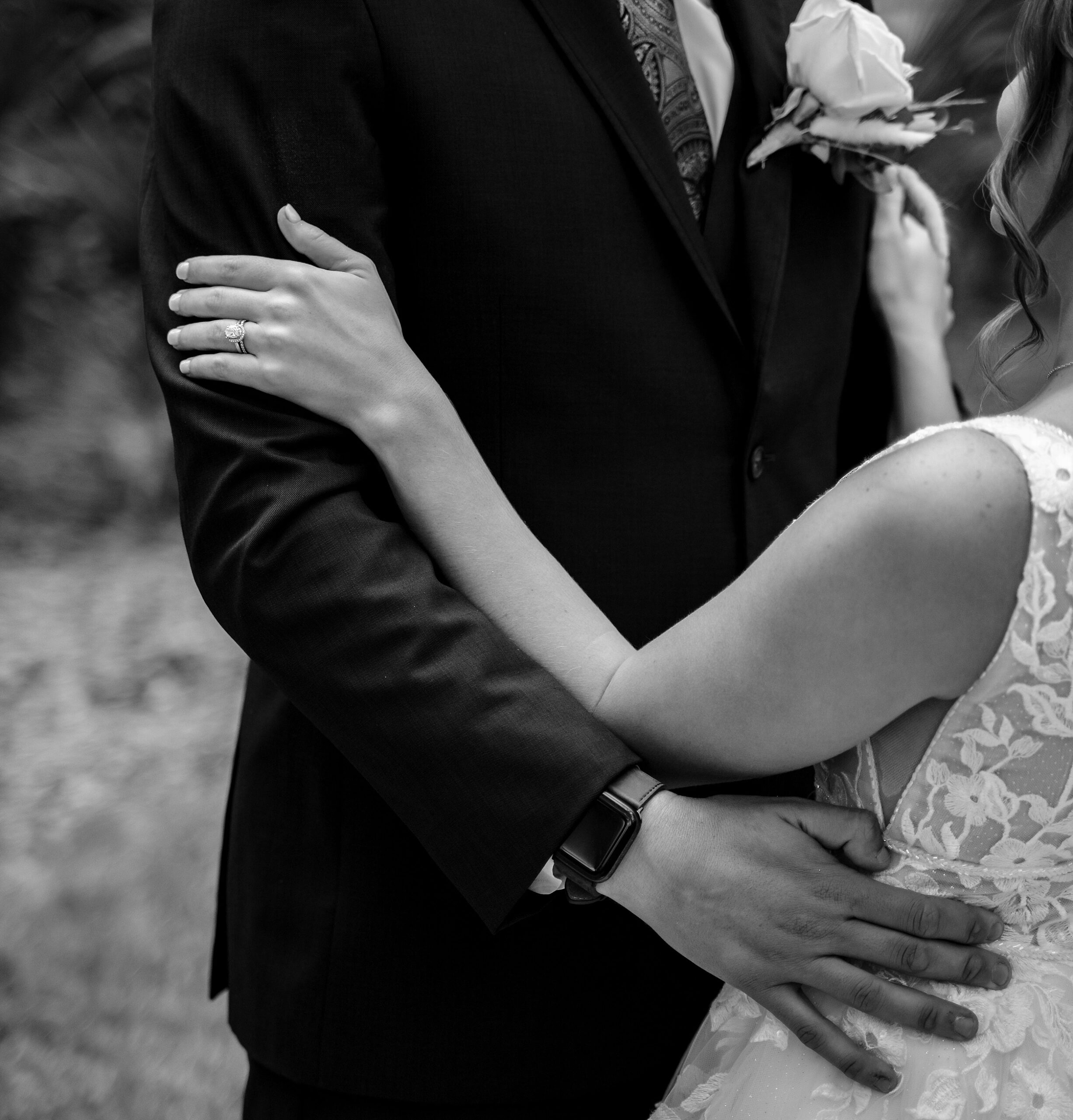 Details of newlyweds dancing in a field