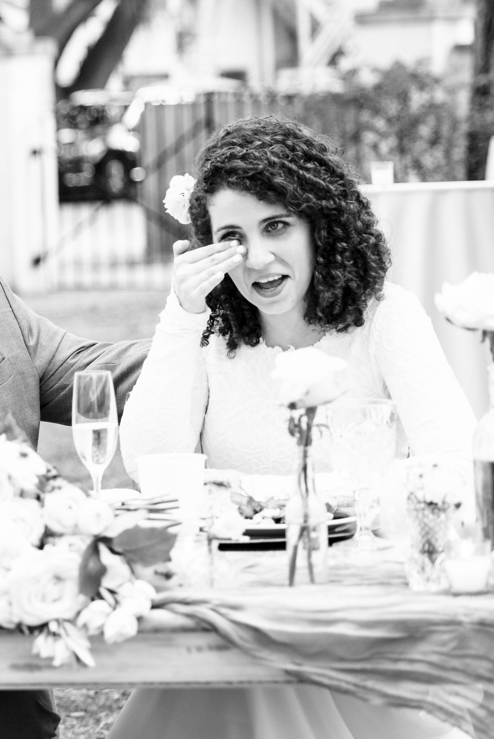 A bride cries during the toasts at the head table of her marsh creek country club wedding