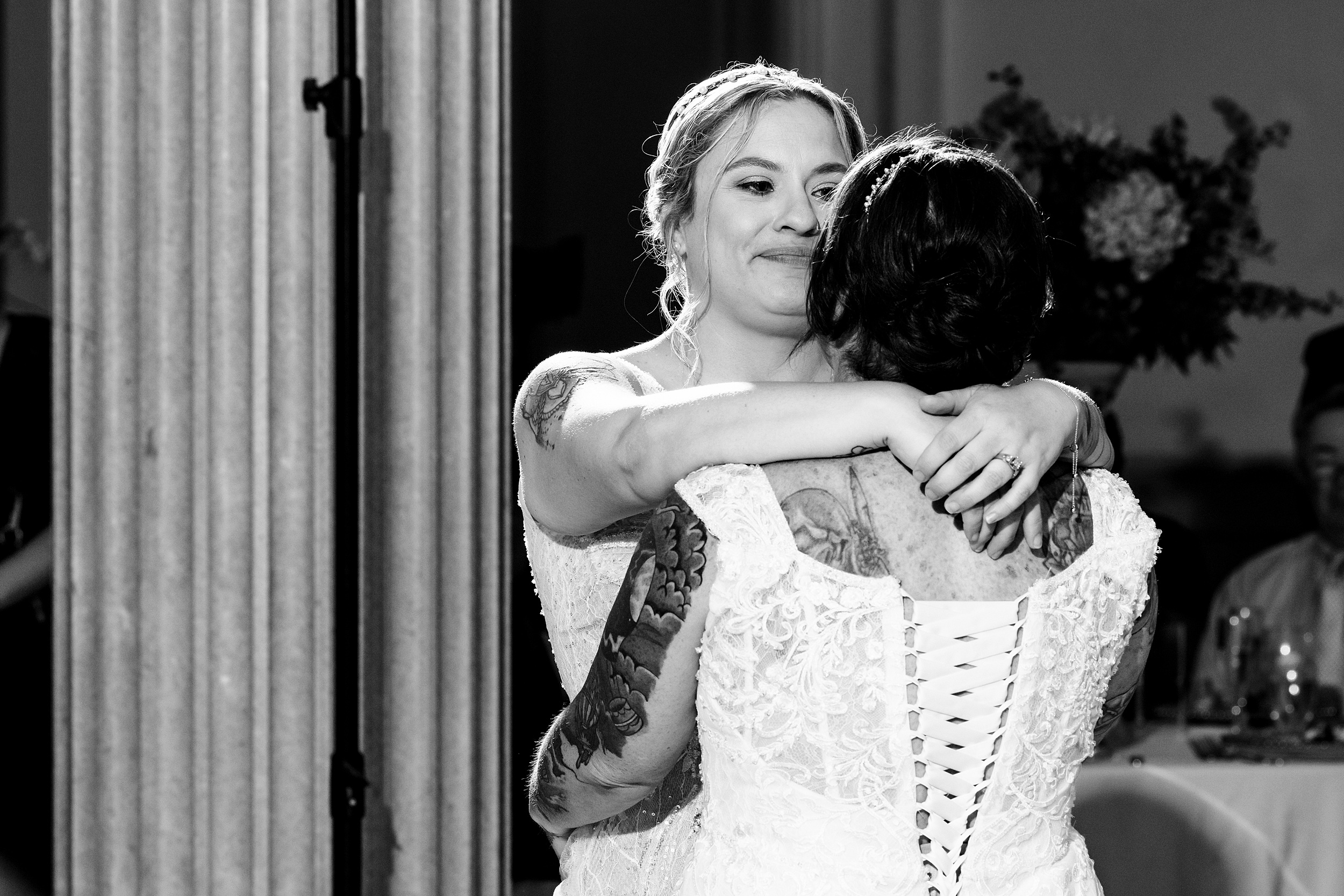 Newlywed brides dance for the first time in lace dresses at their peña-peck house wedding