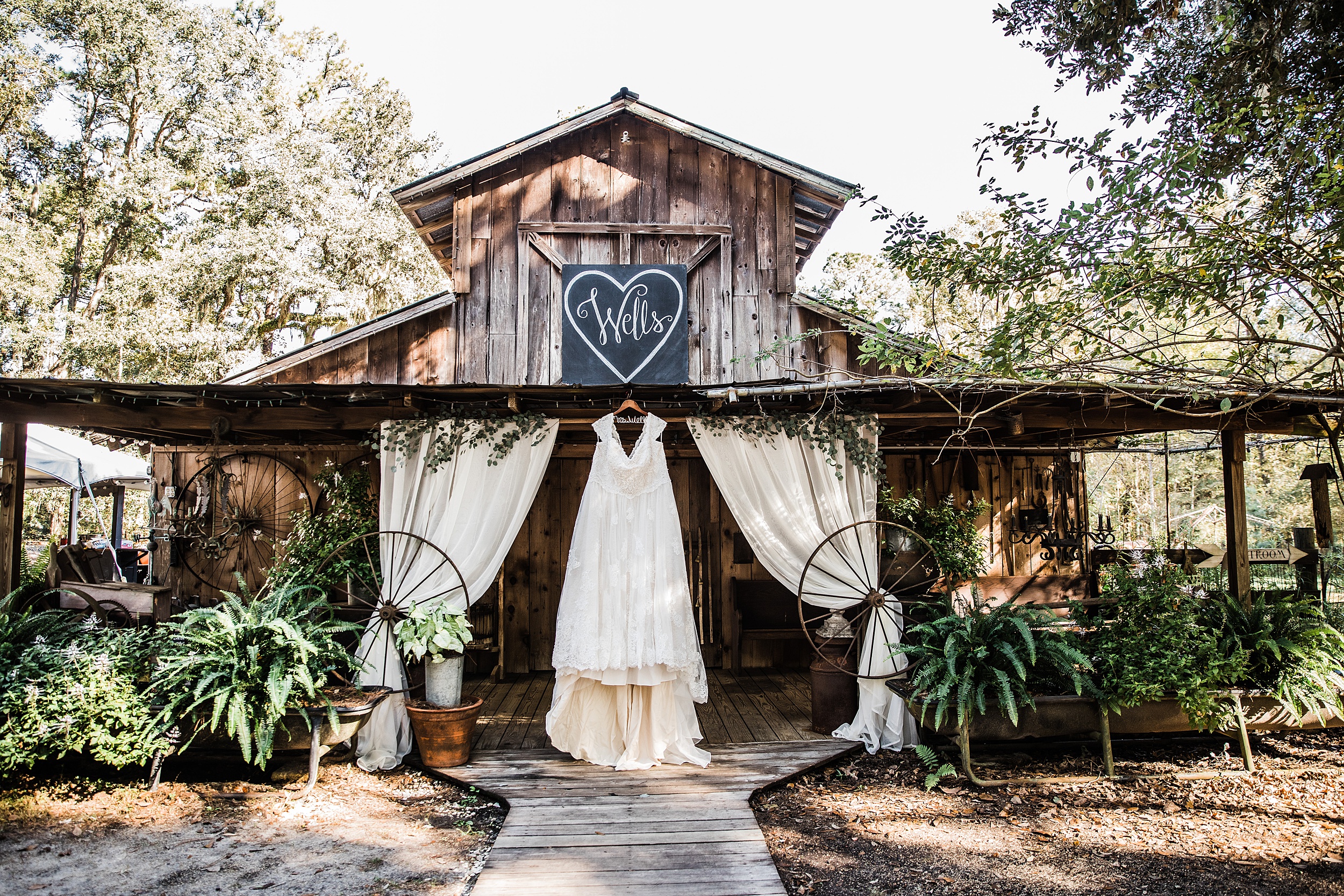 A bride's dress hangs on the porch of a Florida wedding venue