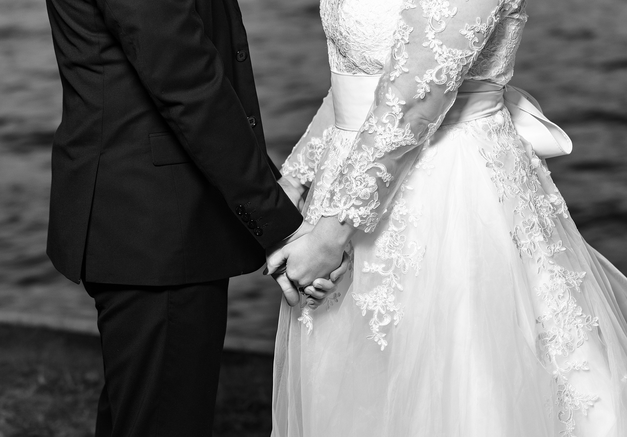 Details of newlyweds holding hands during their the capen house wedding