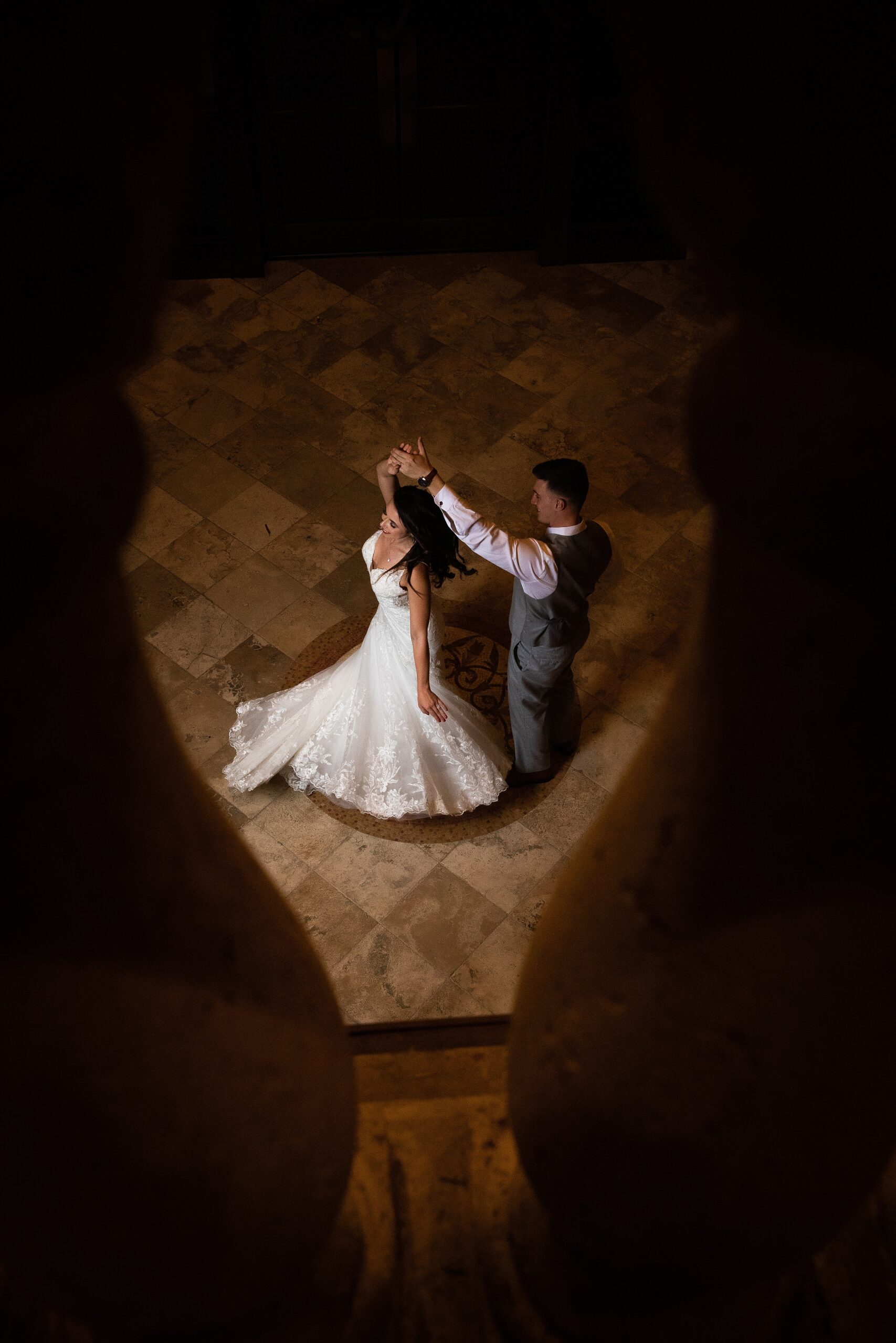 Newlyweds share a quiet dance in the grand foyer at the lodge and club ponte verda wedding venue