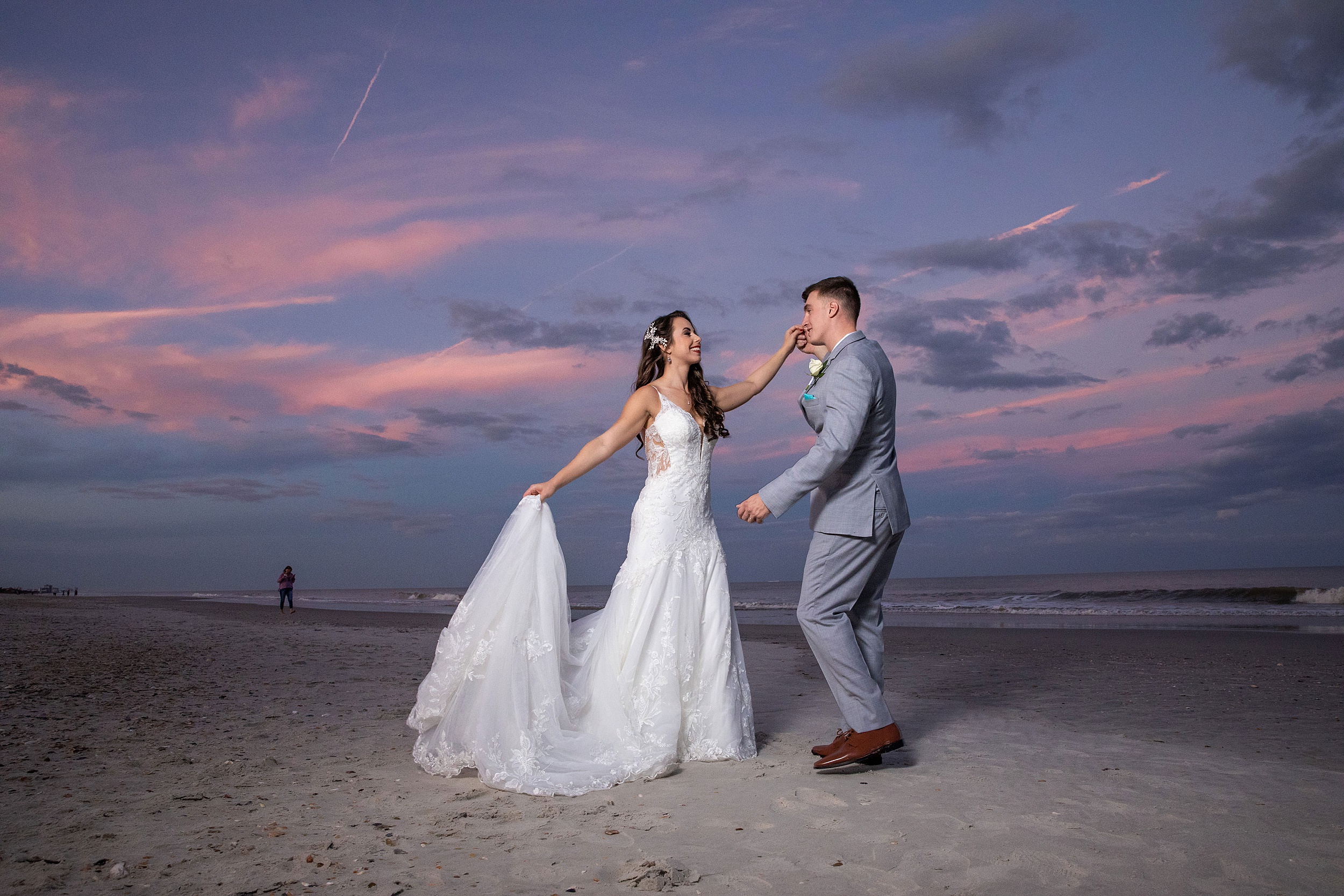 Newlyweds dance on a beach at sunset during their the lodge and club ponte verda wedding