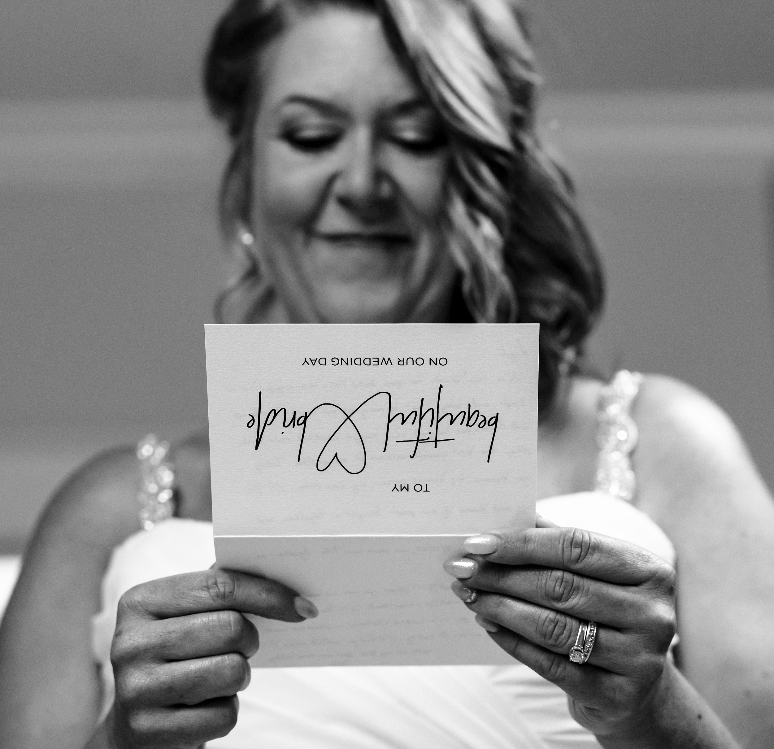 A bride reads her note from her groom before her wedding